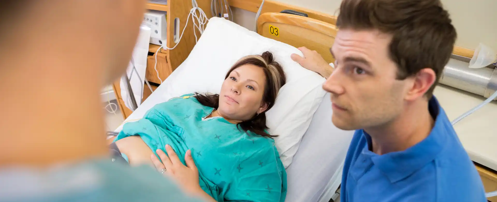 husband waiting to learn baby gender in delivery room